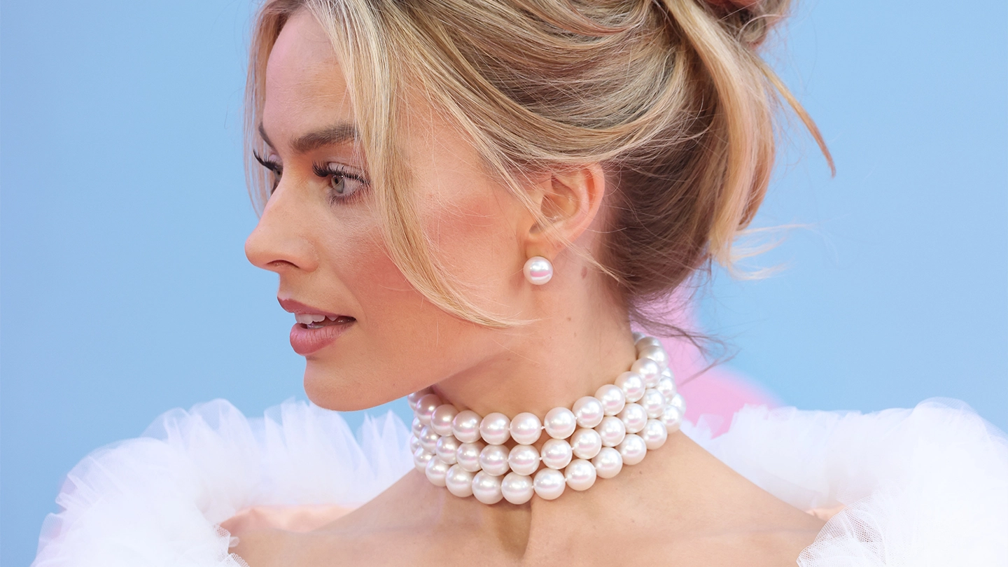 Margot Robbie wearing a triple strand white South Sea pearl necklace and stud earrings