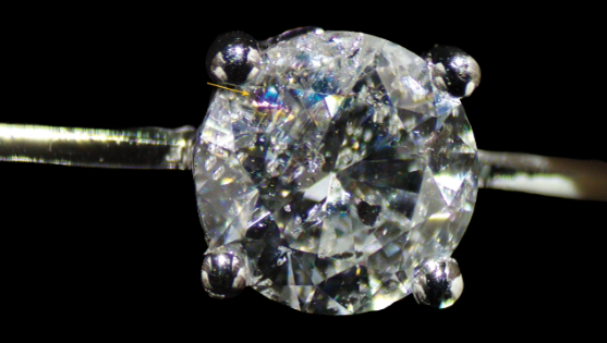 A round brilliant-cut diamond set in the necklace exhibits the flash effect when tilted, a characteristic of fracture filling caused by the presence of a filler within a surface-reaching fracture. Photo by Gaurav Bera. A round brilliant-cut diamond set in the necklace exhibits the flash effect when tilted, a characteristic of fracture filling caused by the presence of a filler within a surface-reaching fracture. Photo by Gaurav Bera.