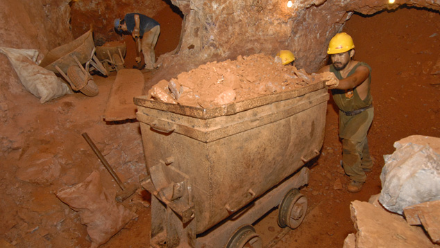 A miner pushes a cart full of waste material in the depths of Bolivia’s Anahi ametrine mine. Photo by Robert Weldon/GIA. A miner pushes a cart full of waste material in the depths of Bolivia’s Anahi ametrine mine. Photo by Robert Weldon/GIA.