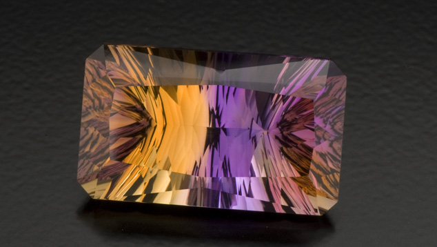 Concave facets on the pavilion contribute to the striking look of this 27.50-ct. ametrine. Creative gem cutters sometimes use concave facets to give a gem a dramatic appearance. Photo by Robert Weldon/GIA, courtesy Minerales y Metales del Oriente. Concave facets on the pavilion contribute to the striking look of this 27.50-ct. ametrine. Creative gem cutters sometimes use concave facets to give a gem a dramatic appearance. Photo by Robert Weldon/GIA, courtesy Minerales y Metales del Oriente.
