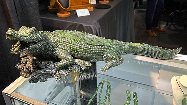 Figure 1. An alligator measuring roughly 29 × 11 × 9 inches fashioned from fine nephrite from the Polar mine in British Columbia. This exceptional hand-carved work was purchased at GJX on opening day. Photo by Jennifer Stone-Sundberg; courtesy of Jade West Corp.