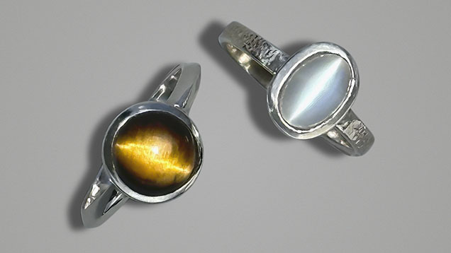 Figure 4. Stones with strong chatoyancy set in sterling silver rings: an 8 mm tiger’s-eye (left) and a 7 × 9 mm cat’s-eye moonstone (right). Courtesy of Jennifer Stone-Sundberg.