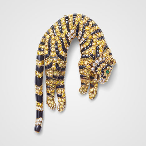 Figure 5. “Tiger” clip brooch, Cartier Paris, 1957. Single- and brilliant-cut diamonds ranging from colorless to various hues of yellow, set with marquise-shaped emeralds (eyes) and onyx (stripes) in gold. Courtesy of the Cartier collection.