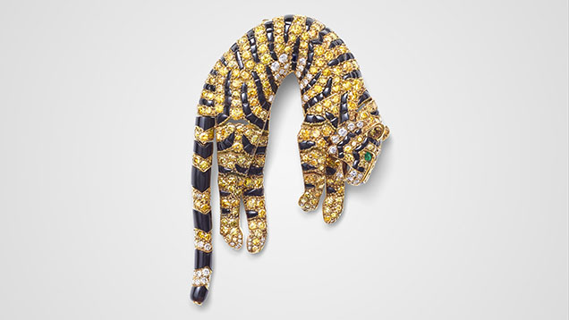 Figure 5. “Tiger” clip brooch, Cartier Paris, 1957. Single- and brilliant-cut diamonds ranging from colorless to various hues of yellow, set with marquise-shaped emeralds (eyes) and onyx (stripes) in gold. Courtesy of the Cartier collection.