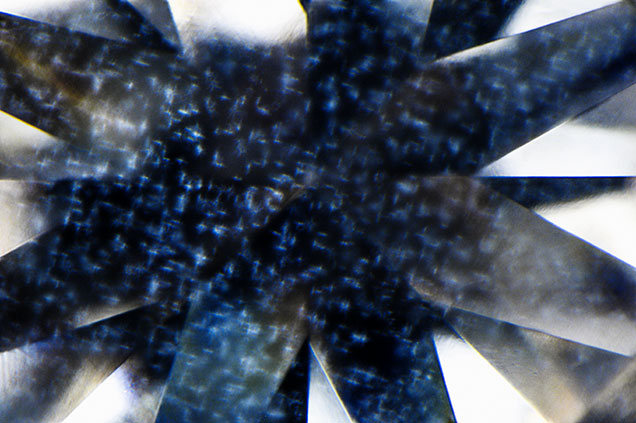 Photomicrograph of a 0.62 carat diamond showing a delicate, interlinked cross-shaped cloud inclusion pattern—an unusual structure not previously observed in GIA laboratories; field of view 2.40 mm. Photomicrograph of a 0.62 carat diamond showing a delicate, interlinked cross-shaped cloud inclusion pattern—an unusual structure not previously observed in GIA laboratories; field of view 2.40 mm.