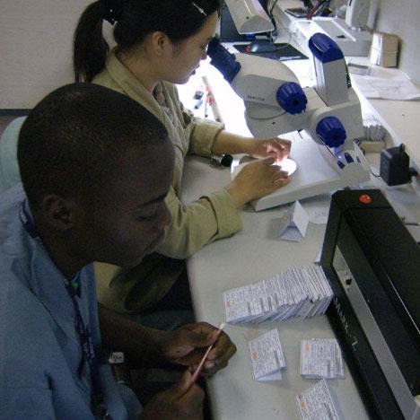 A technician works with a local trainee on the use of rough diamond planning machines. A technician works with a local trainee on the use of rough diamond planning machines.