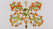 Designed by Bialice Duarte, this butterfly pendant in 18K yellow gold features a fantasy cut green gold quartz, peridot, aquamarine, citrine, tourmaline, and a freshwater rose pearl. 