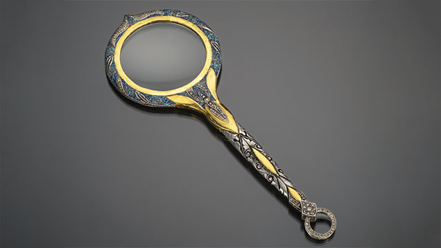Figure 2. Silver magnifying glass with 24K gold embellishments, inlay, carvings, and diamonds. Photo by Robert Weldon; courtesy of Zeki Karaca. Figure 2. Silver magnifying glass with 24K gold embellishments, inlay, carvings, and diamonds. Photo by Robert Weldon; courtesy of Zeki Karaca.