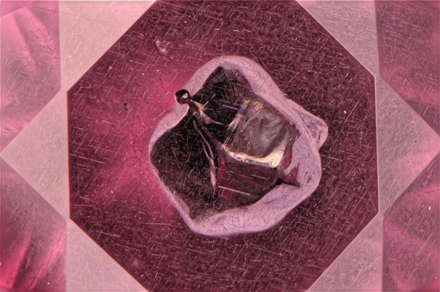 Inclusions surround the sulfide. Inclusions surround the sulfide.