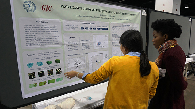 A female student presenting research to another female student A female student presenting research to another female student
