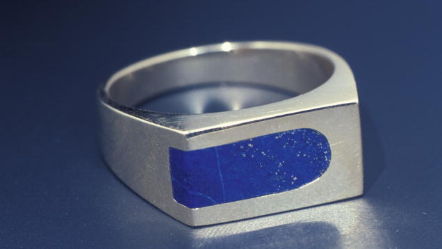 Lapis Lazuli. Inlay, a typical lapis cutting style, is featured in this man’s ring. The gold mounting complements the pyrite flecks in the inlay. - Mike Havstad