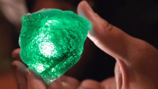 Rough Emerald. A hand-held flashlight reveals the green color of a rough emerald from the Coscuez Emerald mine in Colombia. Photo by Eric Welch/GIA.