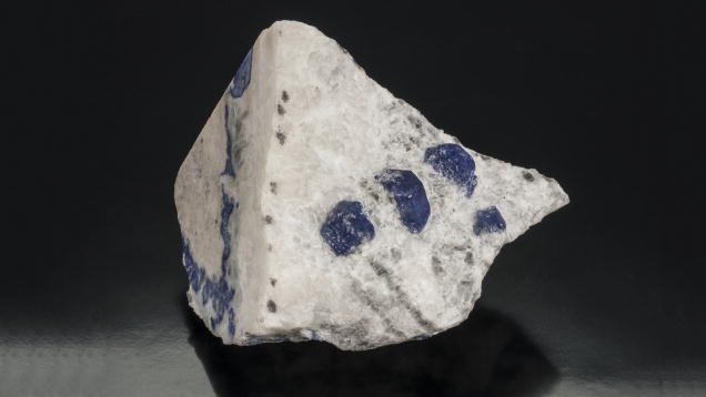 Lapis Lazuli. These lapis lazuli specimens are surrounded by their white calcite matrix host rocks. – Orasa Weldon, gift of William and Jeanne Larson