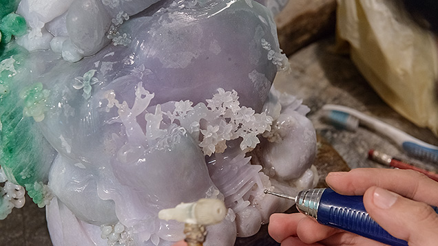 Artist carves jadeite with small metal bur Artist carves jadeite with small metal bur
