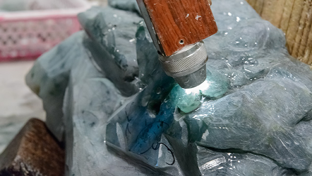 Torch shows color zoning in jadeite rough Torch shows color zoning in jadeite rough