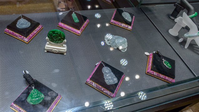 Jadeite pendants, decorations, and bangle in display case Jadeite pendants, decorations, and bangle in display case