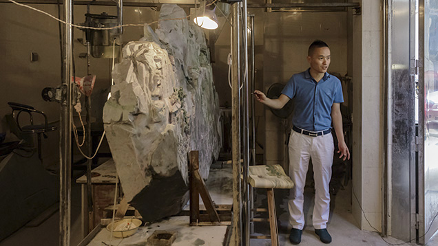 Jadeite carving artist Xingchun Fang and his work in progress Jadeite carving artist Xingchun Fang and his work in progress