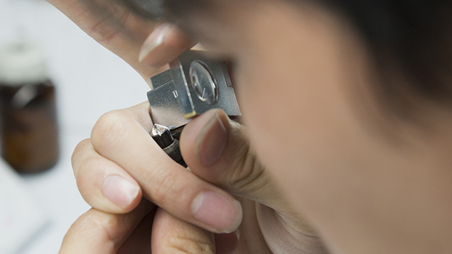 Man looking through loupe Man looking through loupe