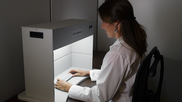 GIA Researcher observing diamonds in a Diamond Dock. GIA Researcher observing diamonds in a Diamond Dock.