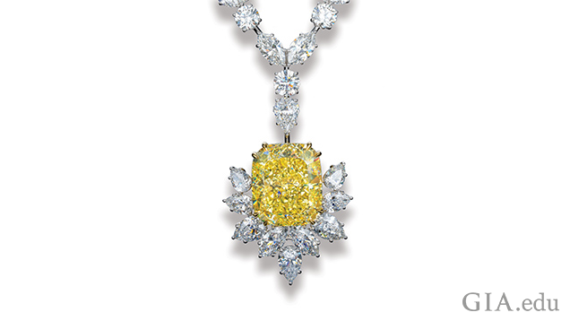 Image of large yellow diamond in setting with other white diamonds. Image of large yellow diamond in setting with other white diamonds.