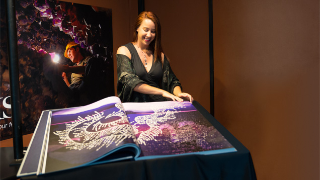 GIA’s Visual Resources Digitization Assistant Emily Lane displaying “Dreams of Diamonds,” which is approximately three feet wide when open. Dona Dirlam, director of the library said the book has already become a tour and student favorite because the oversized photos are making it possible “to see a level of detail and craftsmanship that is rare.”