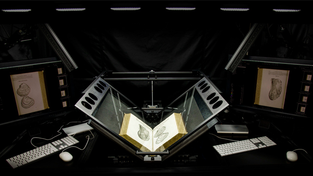 A high-tech digitizing machine cradles the books for scanning instead of forcing them into a flat, spine-damaging position. A high-tech digitizing machine cradles the books for scanning instead of forcing them into a flat, spine-damaging position.