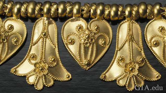 Detail of pendant elements heart and palmette shows twisted wire details (probably cast) and granulation soldered on. Detail of pendant elements heart and palmette shows twisted wire details (probably cast) and granulation soldered on.