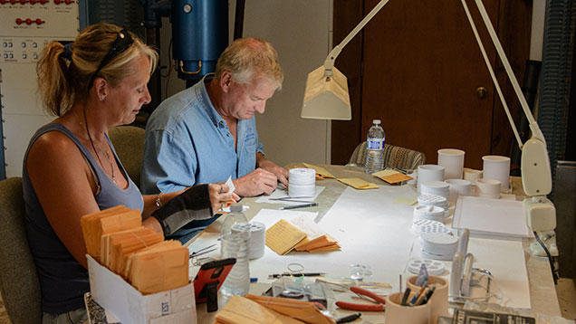Man and woman working on clients’ stones Man and woman working on clients’ stones