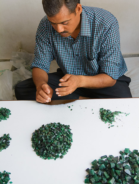 Man sorting rough emerald Man sorting rough emerald