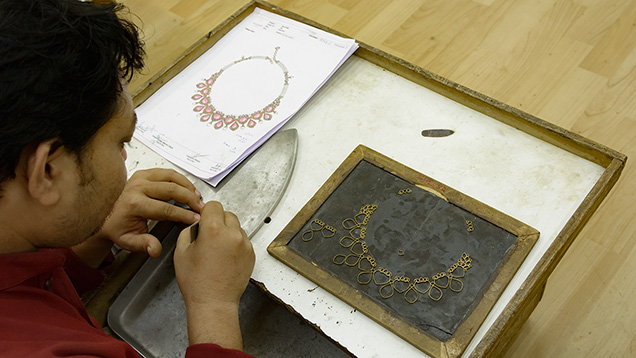 Jeweler making gold frame Jeweler making gold frame