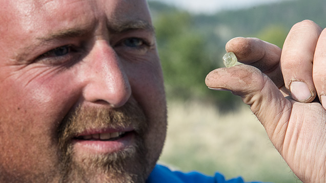 Miner with rough sapphire