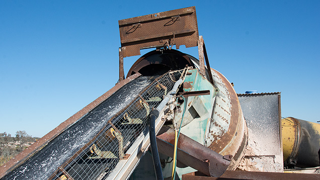 Tilted rotating barrel and conveyor belt