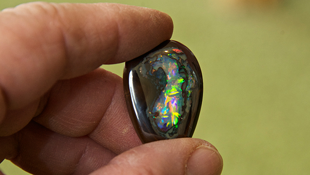 Hand holding boulder opal