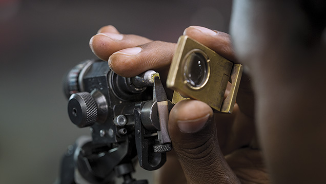 Cutter examines diamond facets Cutter examines diamond facets