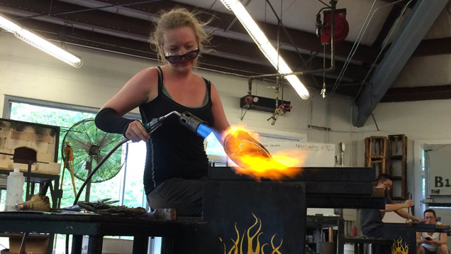 Grandics works with fire and glass in a studio.