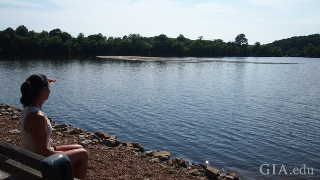 Woman looking at pearl farm on lake