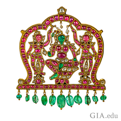 Gold pendant featuring carved drawings of indian gods and emeralds and rubies Gold pendant featuring carved drawings of indian gods and emeralds and rubies