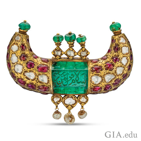 Horn shaped jewel pendant featuring emeralds, rubies, diamonds and pearls, and shows engravings in Arabic. Horn shaped jewel pendant featuring emeralds, rubies, diamonds and pearls, and shows engravings in Arabic.