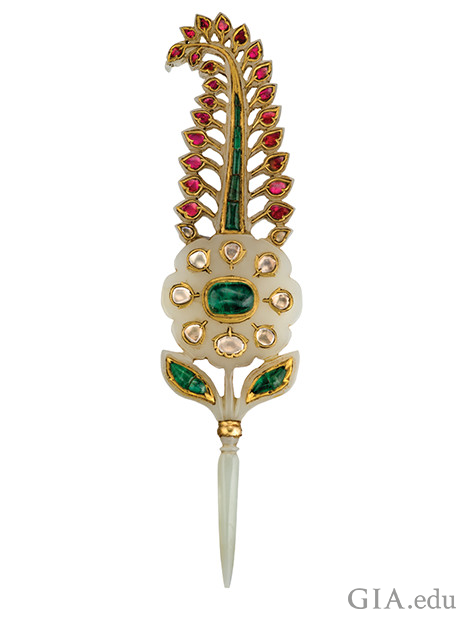 Ornament in the shape of a feature made of jewels with a pointed blade toward the bottom of the piece Ornament in the shape of a feature made of jewels with a pointed blade toward the bottom of the piece