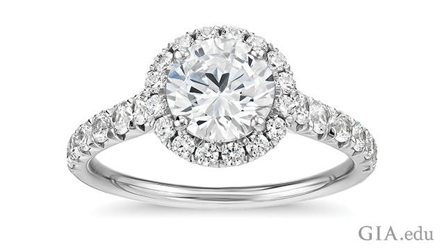 Image of engagement ring showing a single diamond surrounded by a halo of melee diamonds.. Melee used to create a halo can add additional sparkle and make the center stone appear larger. This platinum engagement ring features a 1 ct center stone with 0.5 total carat weight of melee in the halo and shank. Courtesy of Blue Nile.