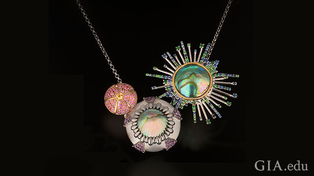 This urchin necklace is composed of two Eyris pearls accented with blue, pink and yellow sapphires, tsavorite garnets and amethysts. This urchin necklace is composed of two Eyris pearls accented with blue, pink and yellow sapphires, tsavorite garnets and amethysts.