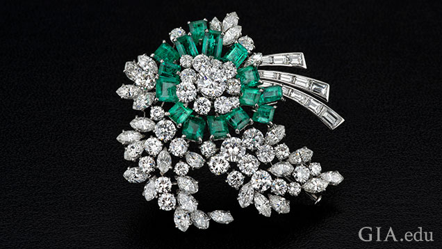 Emerald and diamond brooch.