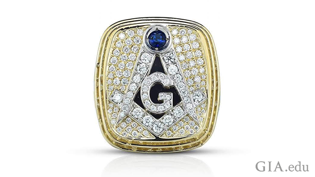 A square shaped yellow and white gold ring with masonic symbols. A square shaped yellow and white gold ring with masonic symbols.