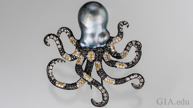 The octopus head is a baroque Tahitian cultured pearl and its arms are made of black, yellow and white diamond (in a striped pattern) set in black-plated 18K gold. The octopus head is a baroque Tahitian cultured pearl and its arms are made of black, yellow and white diamond (in a striped pattern) set in black-plated 18K gold.