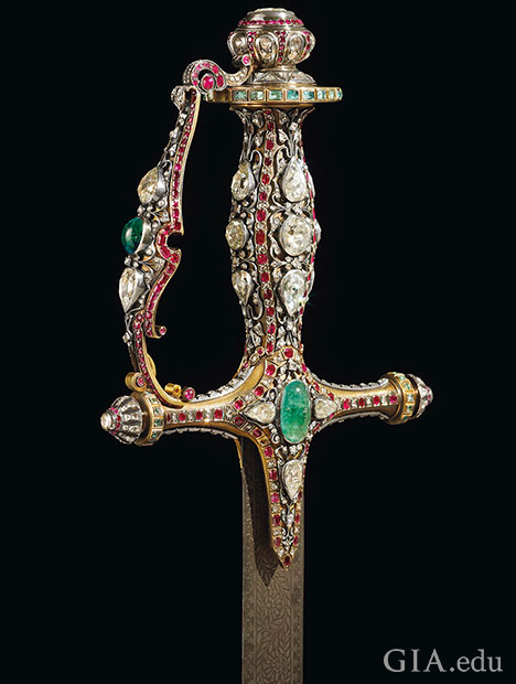 The handle of the sword is embellished with large traditional Mughal cut diamonds, rubies and emeralds.
