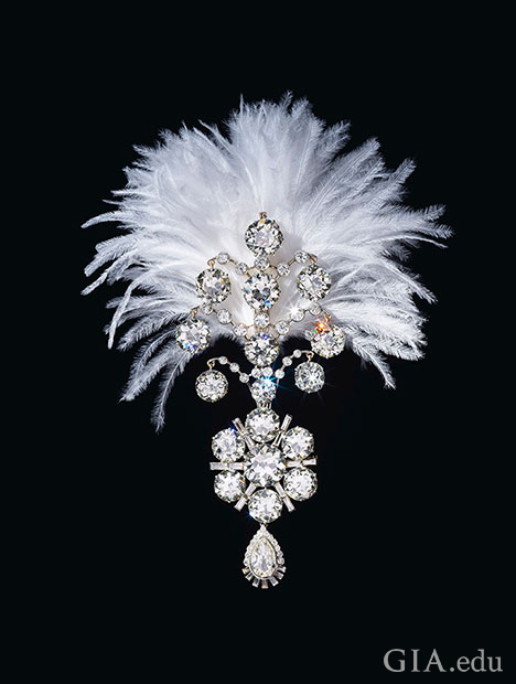 A diamond brooch topped with a white feather plume.