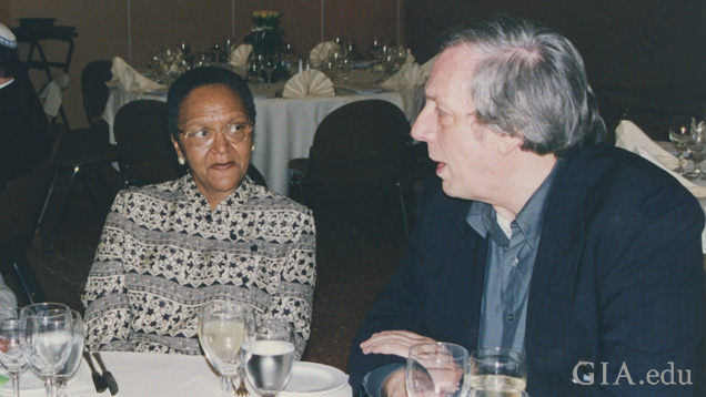 A woman and man sit at a dinner table talking. A woman and man sit at a dinner table talking.