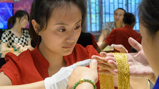 Sales associate holding gold jewelry Sales associate holding gold jewelry