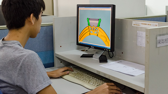 Worker using CAD/CAM to convert a hand drawing into a computer file Worker using CAD/CAM to convert a hand drawing into a computer file