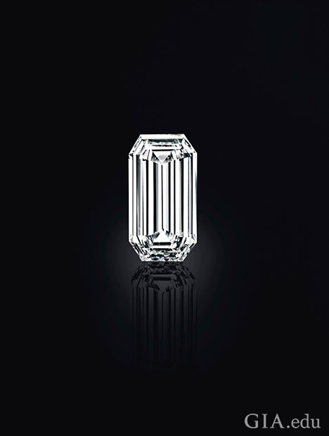 A cut corner rectangular shaped diamond on a black background.